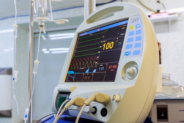 Close-up of advanced ventilation equipment and monitor used in intensive care units for supporting critically ill patients.