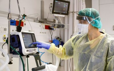Patient on ventilator in ICU with monitoring equipment